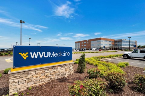 a sign for wvu medicine in front of a building