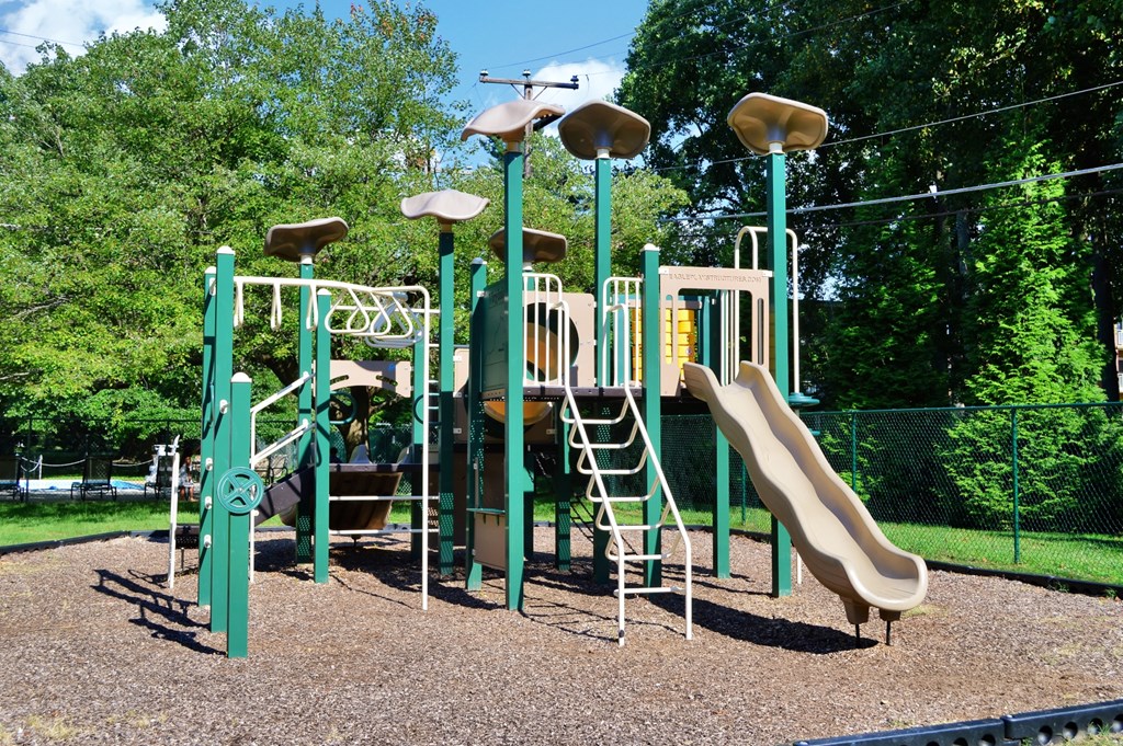 a playground with a slide and other playground equipment