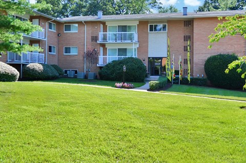 a large lawn in front of an apartment building