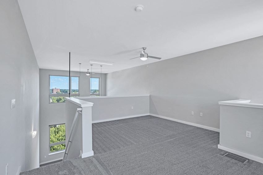 the living room and dining room of an empty home with white walls