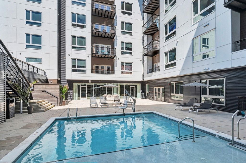 a swimming pool in front of an apartment building