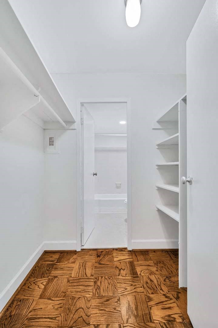 a bedroom with a medium sized bed and a closet with a mirrored door