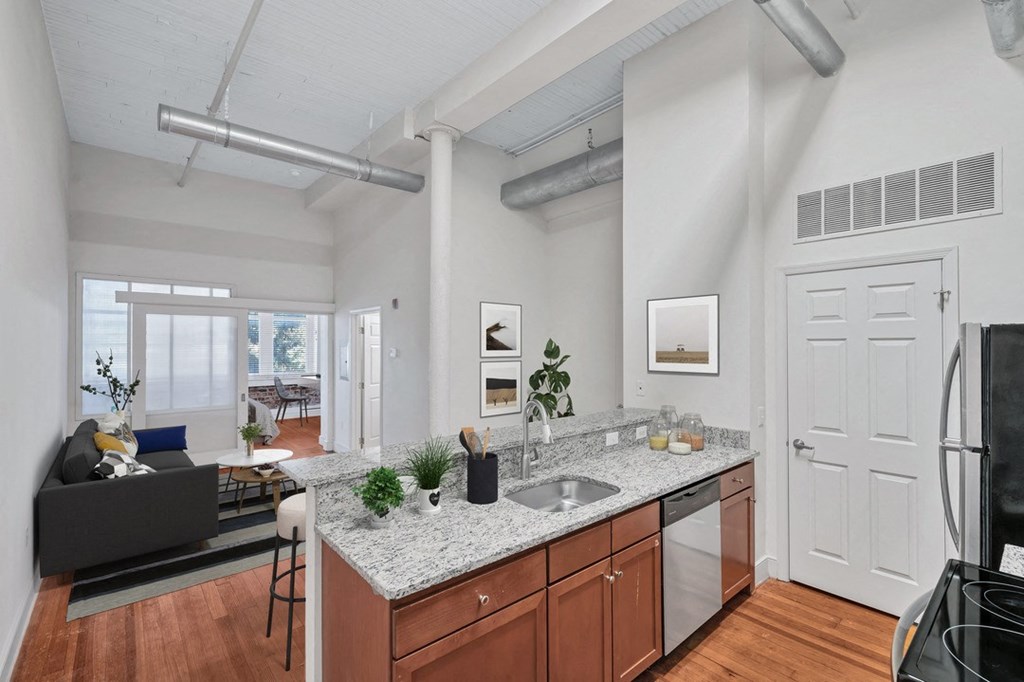an open living room with a kitchen with a counter top