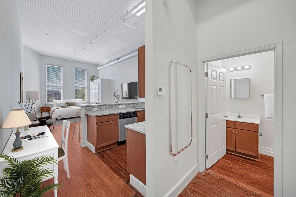 a kitchen and living room with a refrigerator and a sink