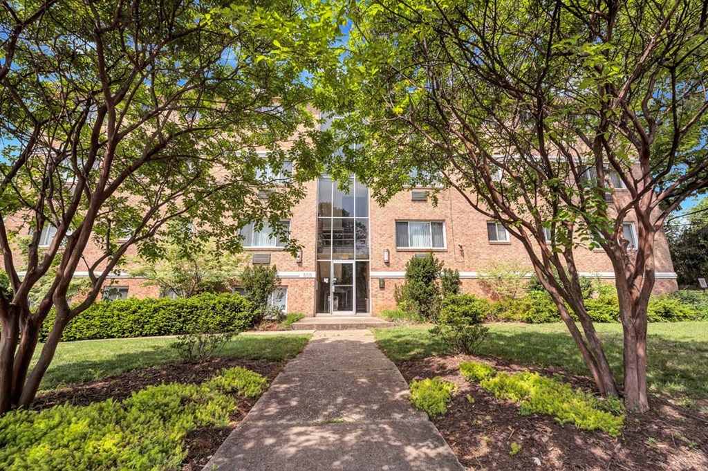 a brick building with trees in front of it