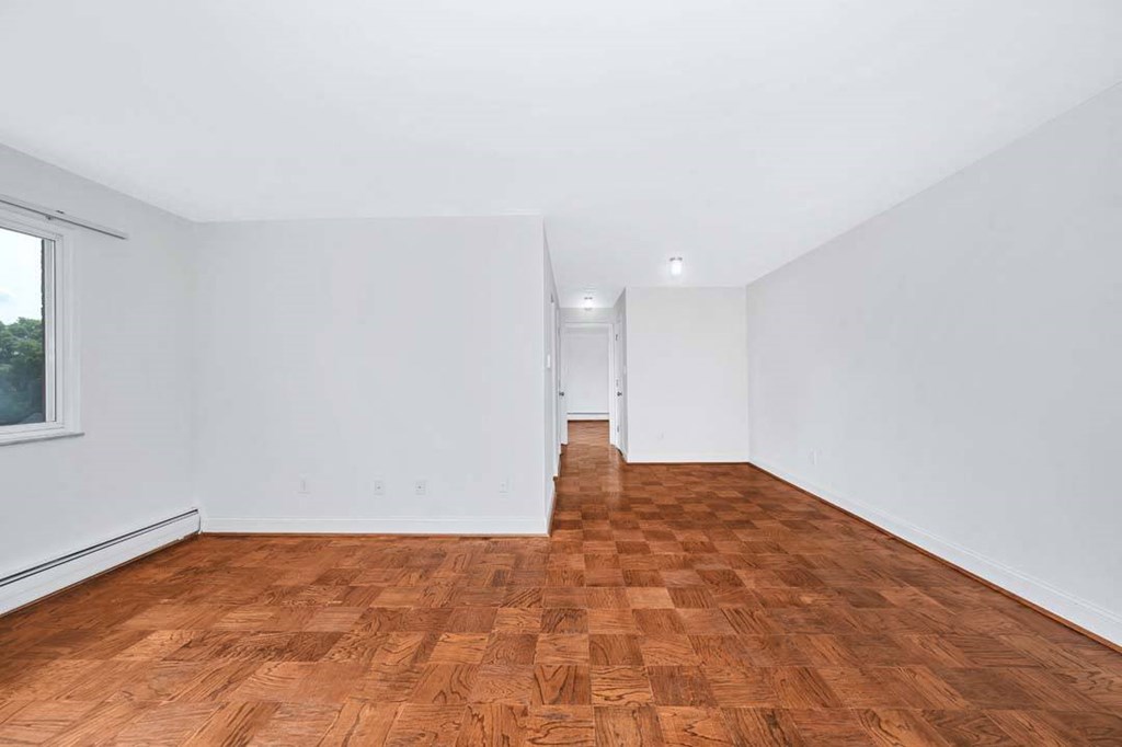 a room with a wooden floor and white walls