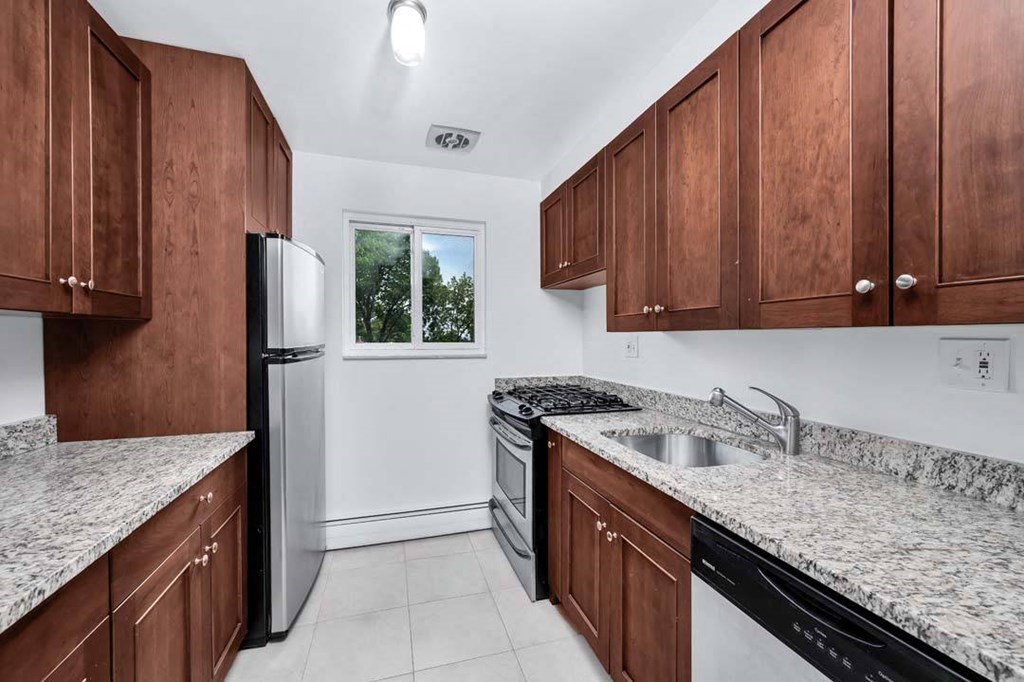 a kitchen with a stove top oven next to a refrigerator
