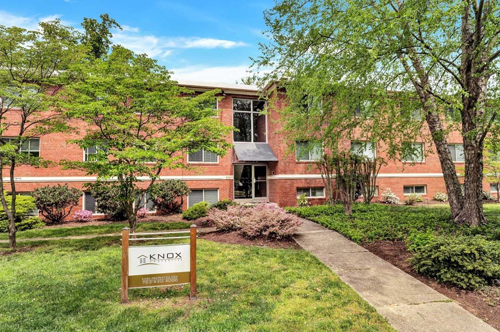 a brick building with a sign in front of it