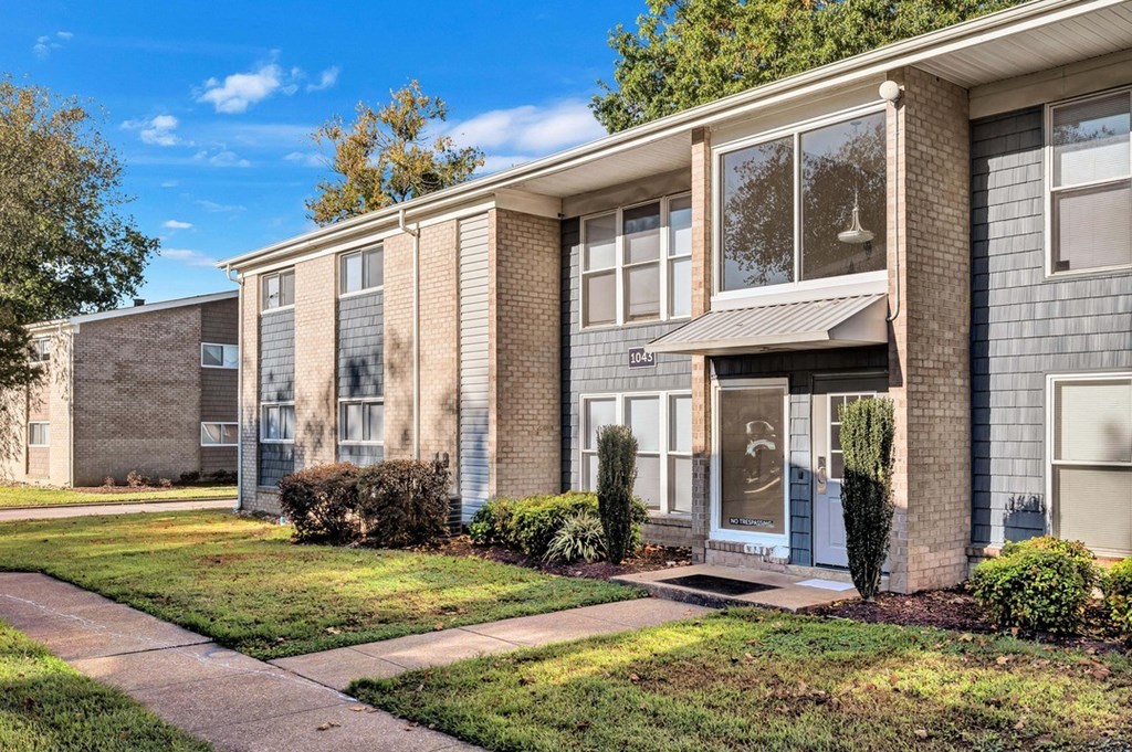 a brick apartment building with a blue sky in the background