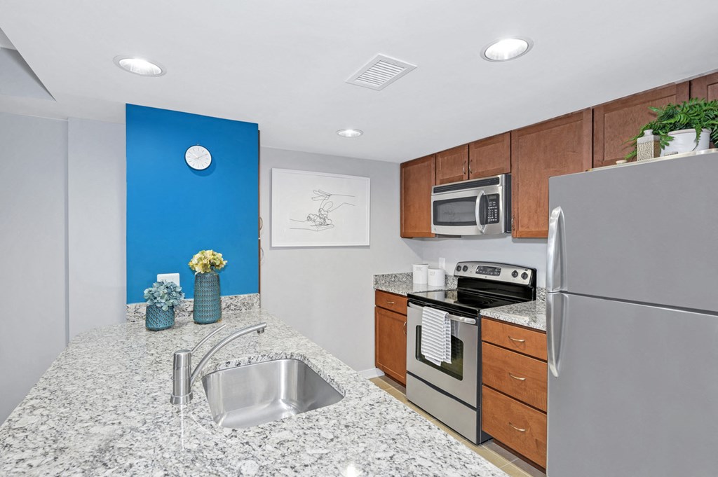 a kitchen with granite counter tops and stainless steel appliances