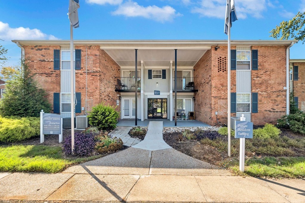 a brick building with two flags in front of it