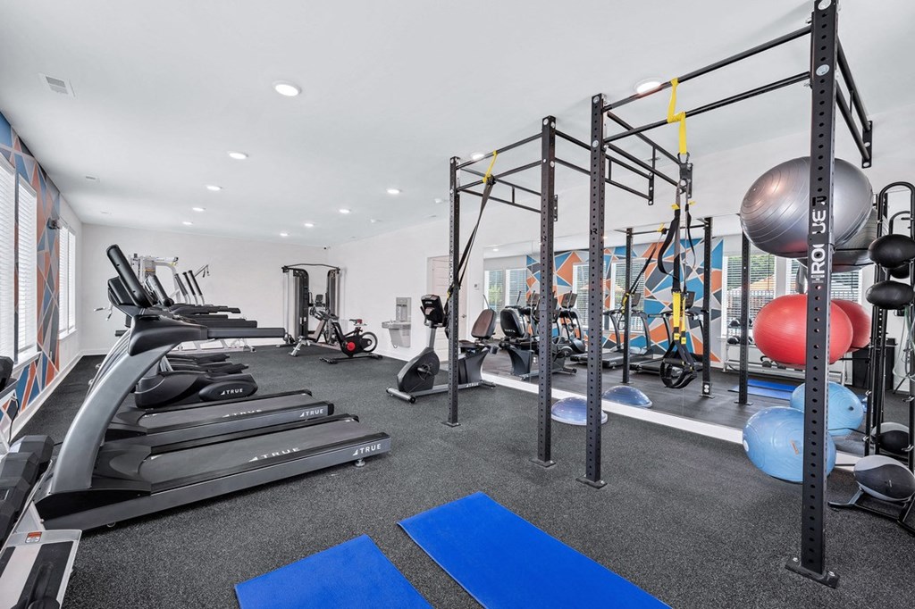 a gym with treadmills and other exercise equipment