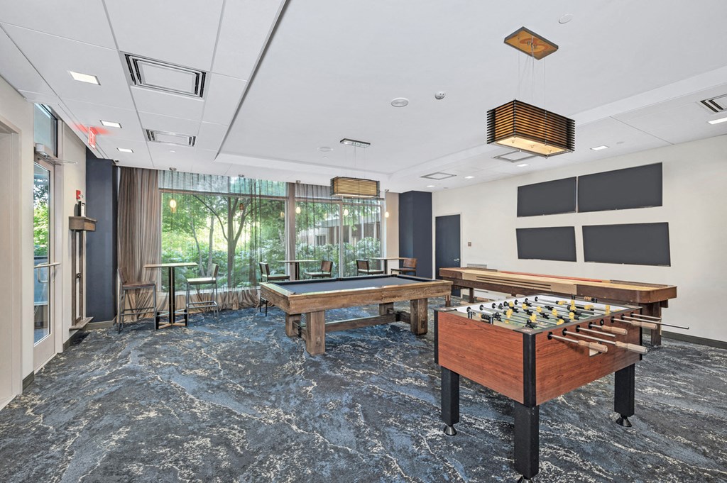 a game room with a foosball table and a pool table