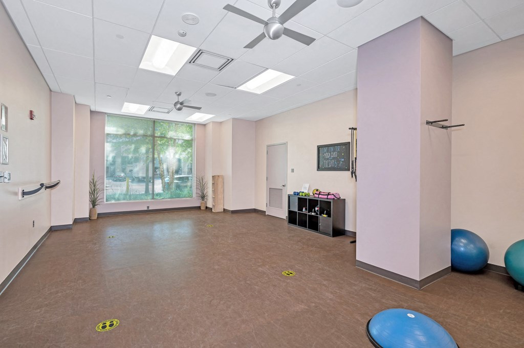 room with exercise balls and a ceiling fan