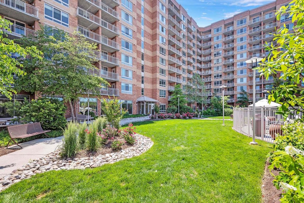 an apartment yard with a large building in the background
