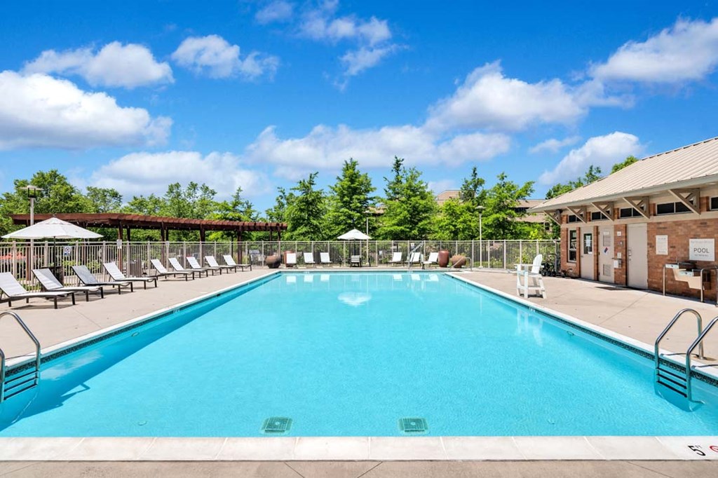 the swimming pool at the resort combines a large pool with lounge chairs