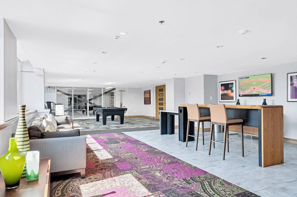 a living room with a bar and a table with chairs