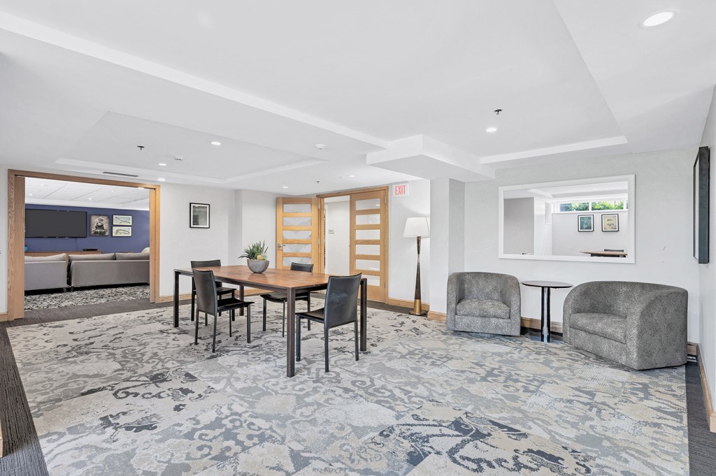 a living room with a dining room table and chairs
