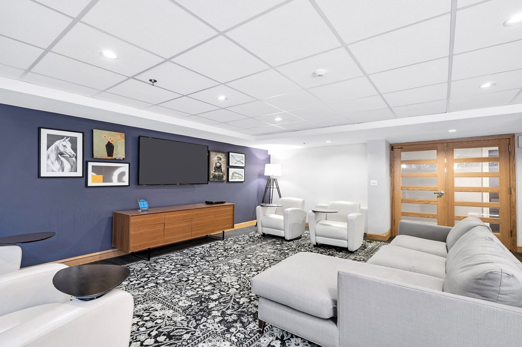 a living room with couches and chairs and a television