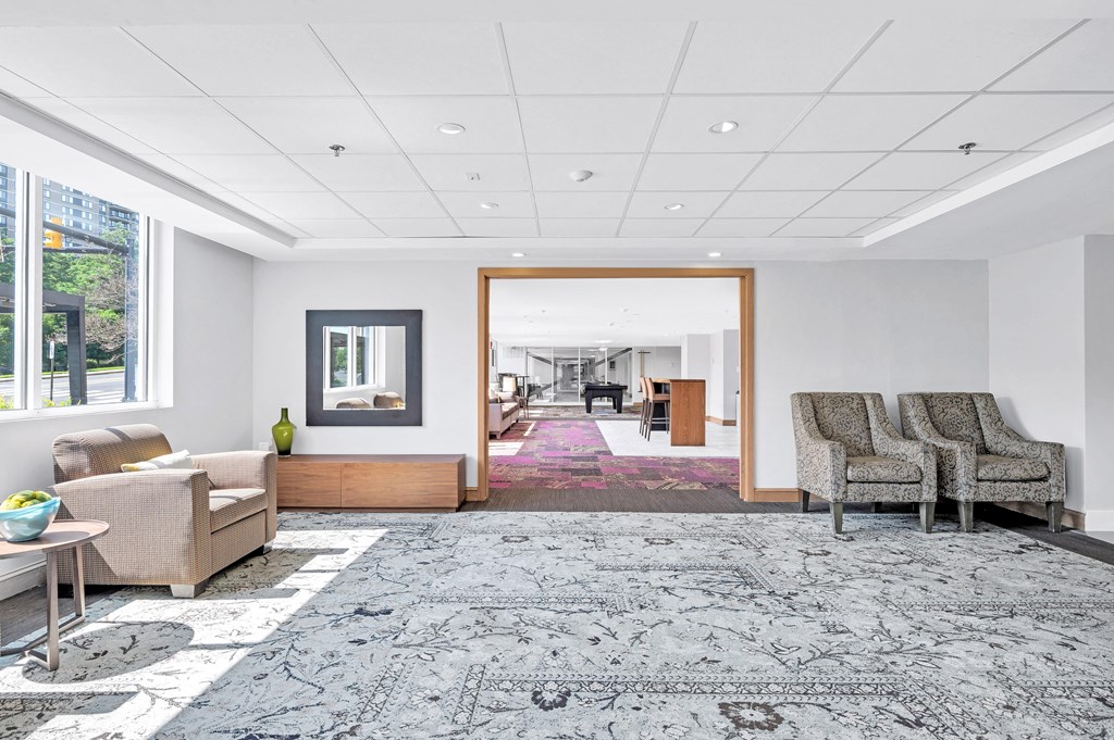 a living room with couches and chairs and a rug