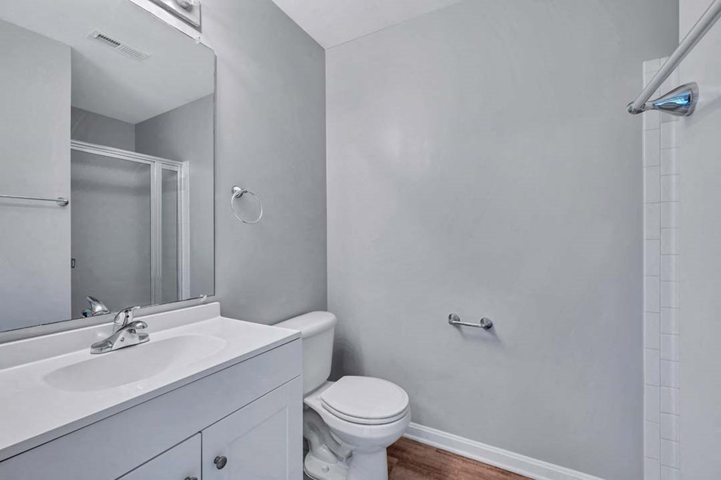 a bathroom with a sink toilet and a mirror