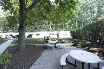 a picnic area with tables and benches in a park