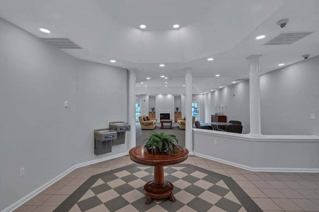 a lobby with a table and a checkered floor