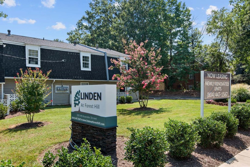 a home for sale with a sign in front of it