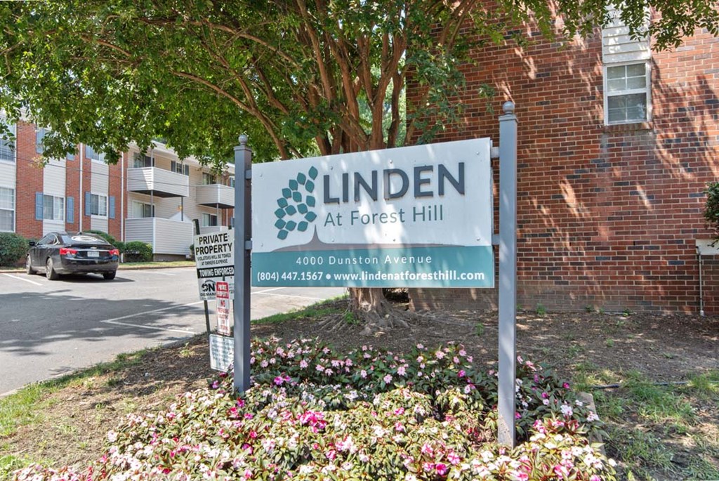 a sign in front of a brick building
