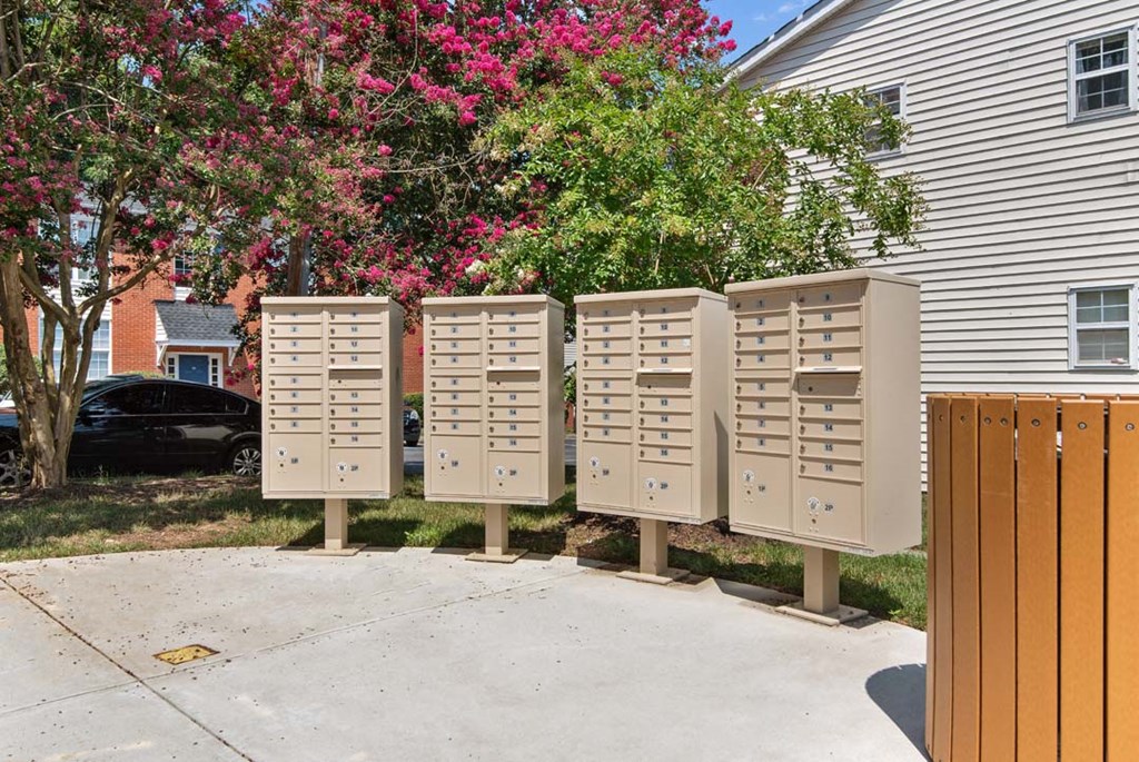 a row of mailboxes on the side of a house