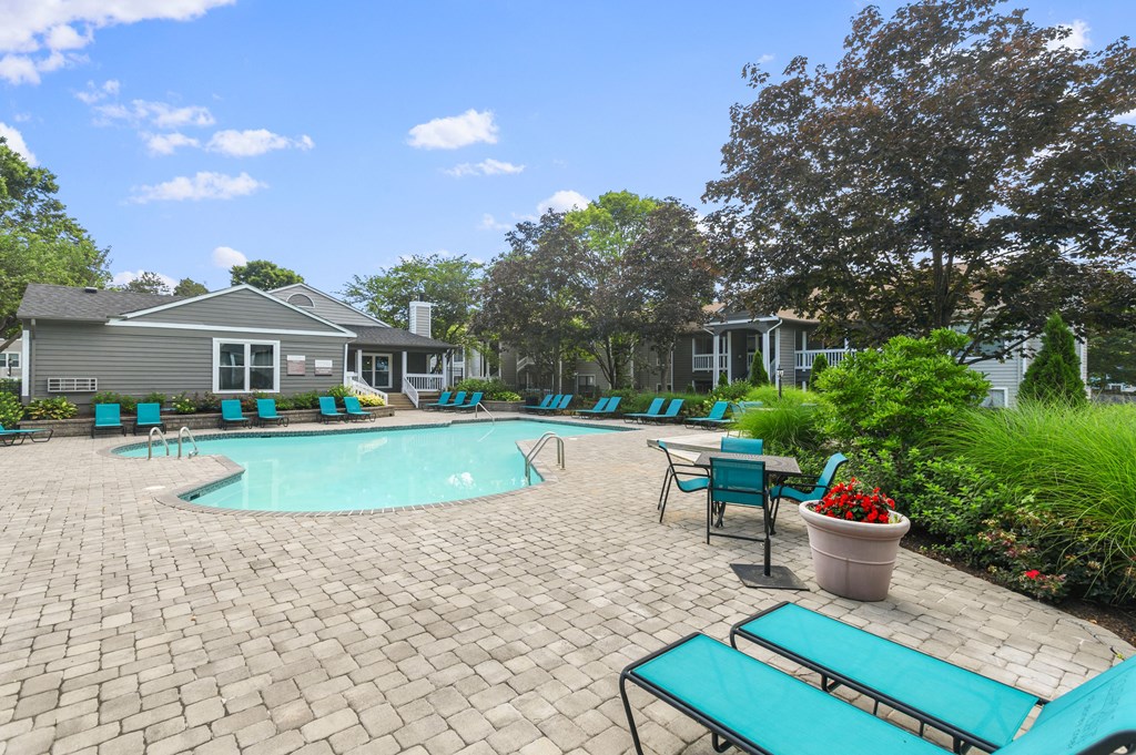 the preserve at ballantyne commons pool and patio with blue chairs and a pool