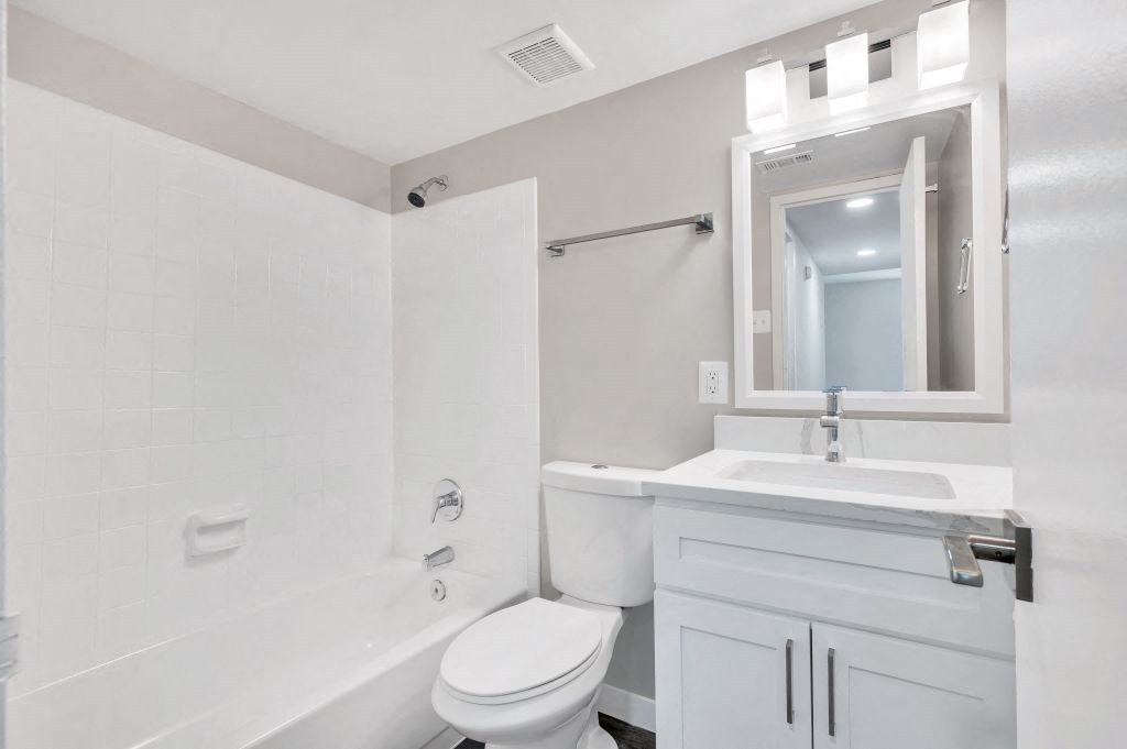 a white bathroom with a sink and a toilet