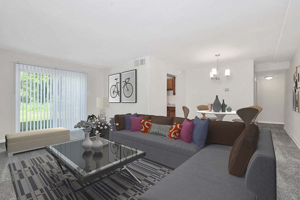 a living room with a couch and a glass coffee table