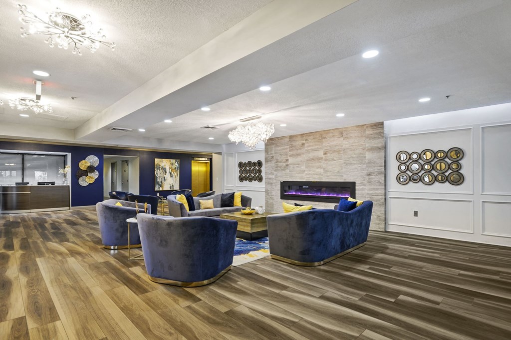 a living room with couches and chairs and a fireplace