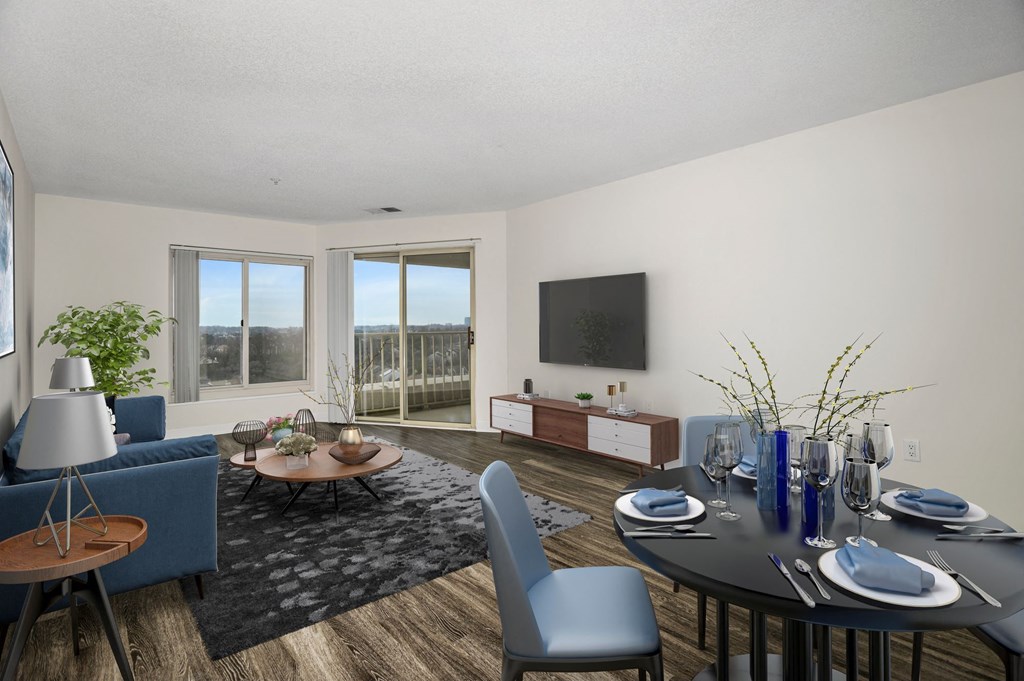 a living room and dining room with a table and chairs and a television