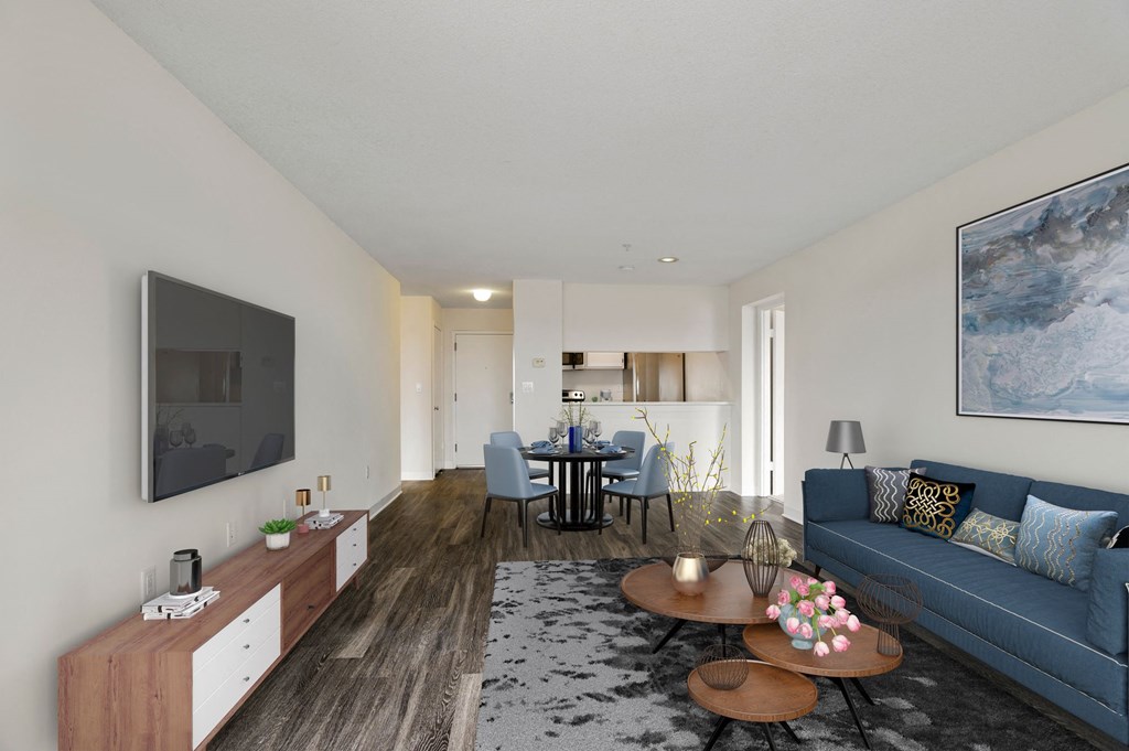 a living room with a blue couch and a table and a television