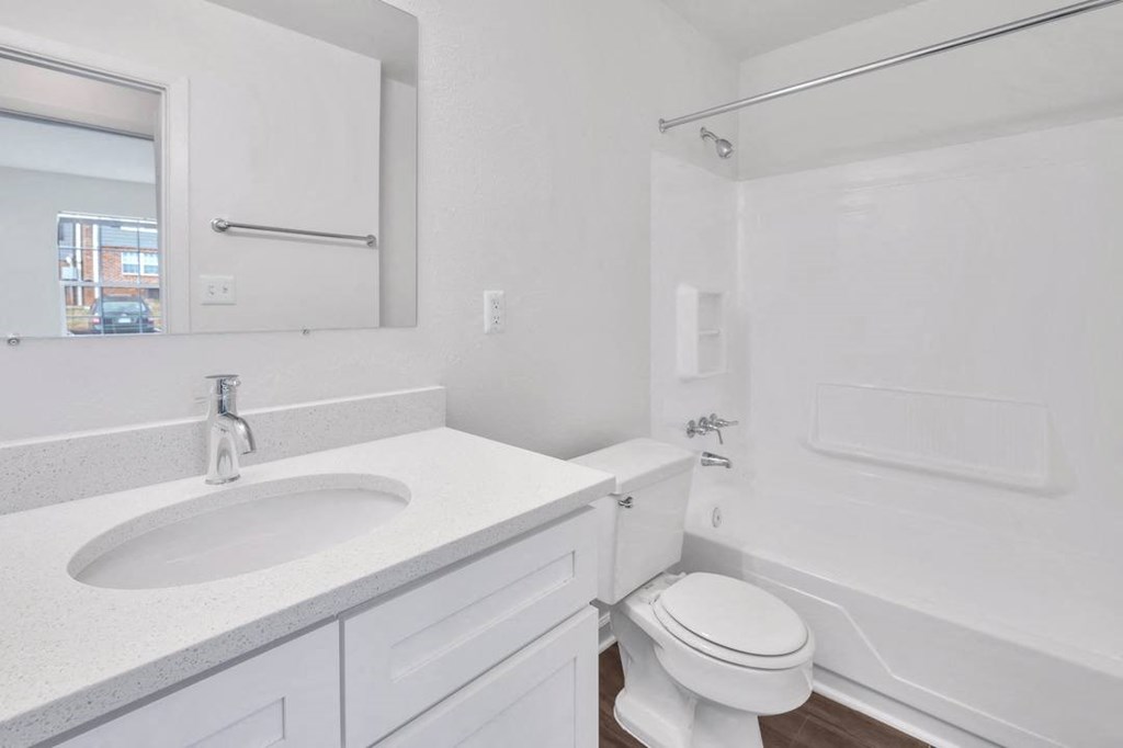 a bathroom with a sink toilet and a mirror