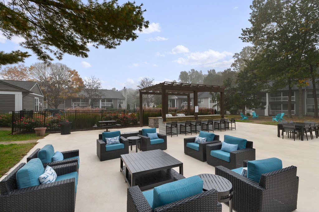 a patio with chairs and tables and a gazebo