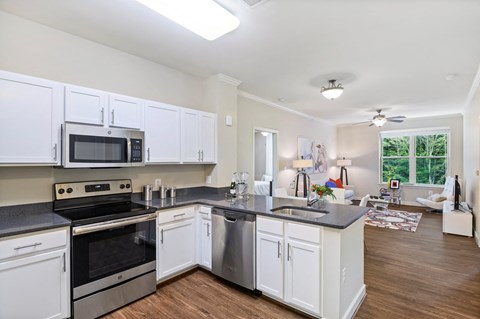 a kitchen with white cabinets and stainless steel appliances