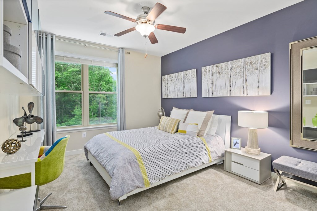 a bedroom with a bed and a ceiling fan