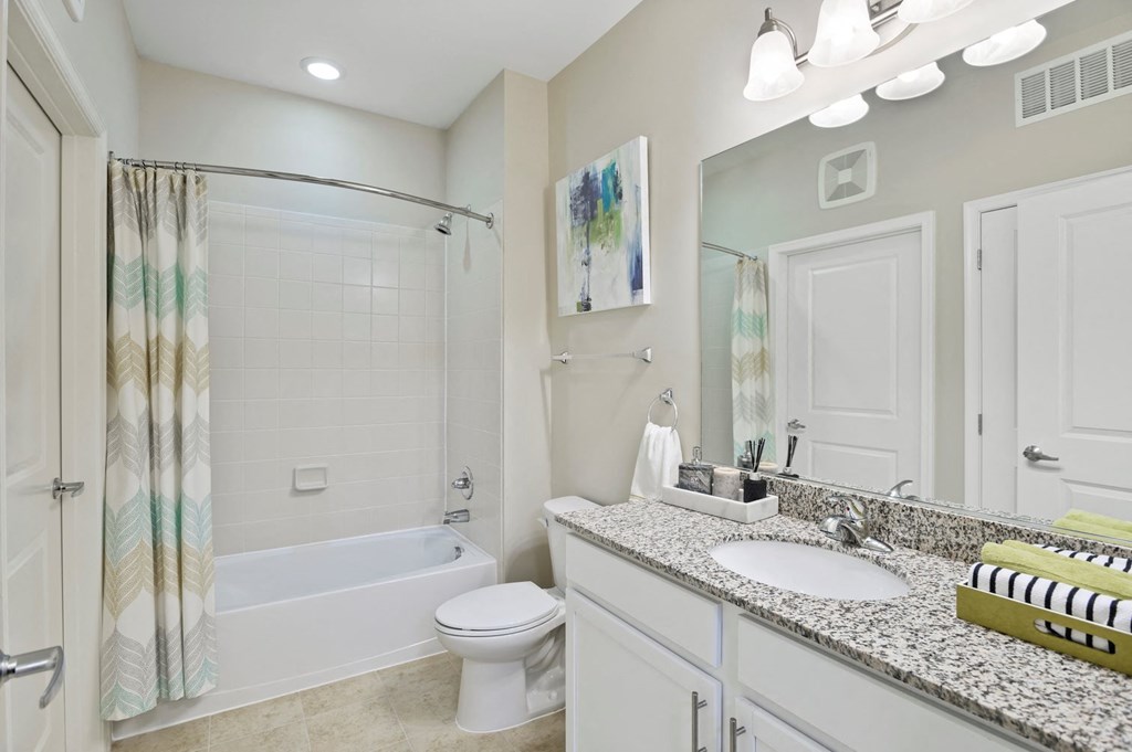 a bathroom with a sink and a shower and a toilet