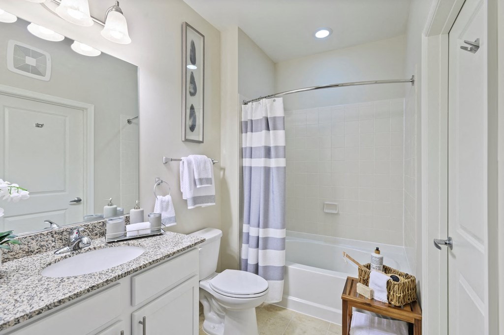a bathroom with a shower and a sink and a toilet