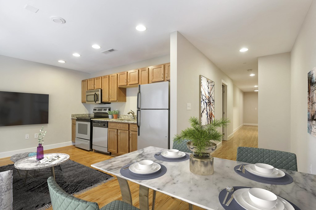 a kitchen and dining room with a table and chairs