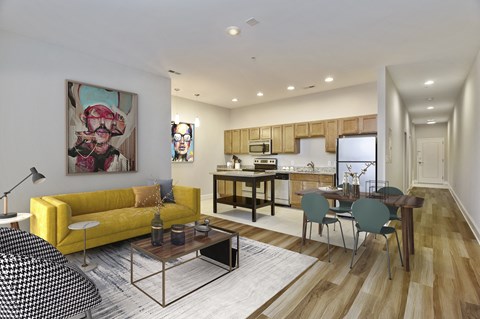 a living room with a yellow couch and a dining room table