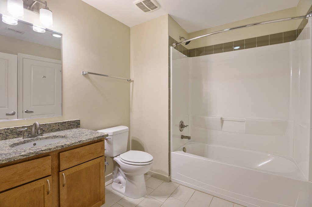 a bathroom with a shower toilet and sink