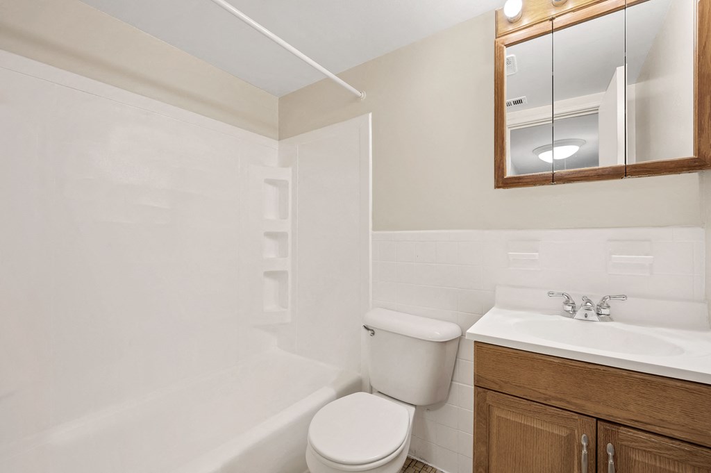 a bathroom with a toilet sink and a mirror