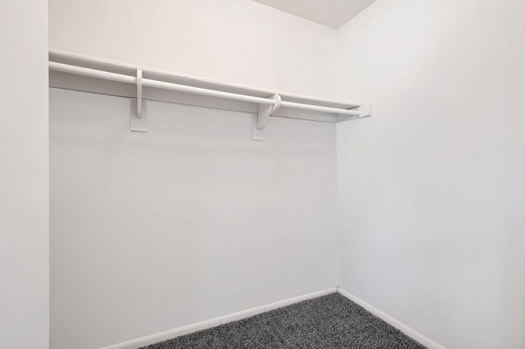 an empty room with a white wall and a whiteretchedretchedretched closet door