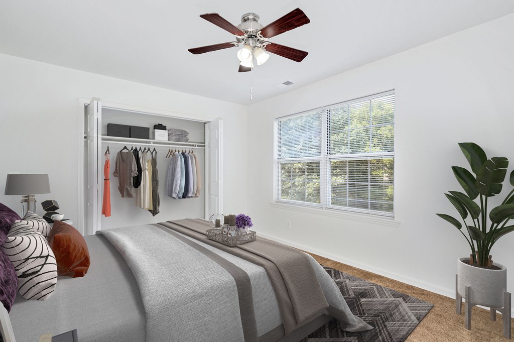 a bedroom with a bed and a ceiling fan