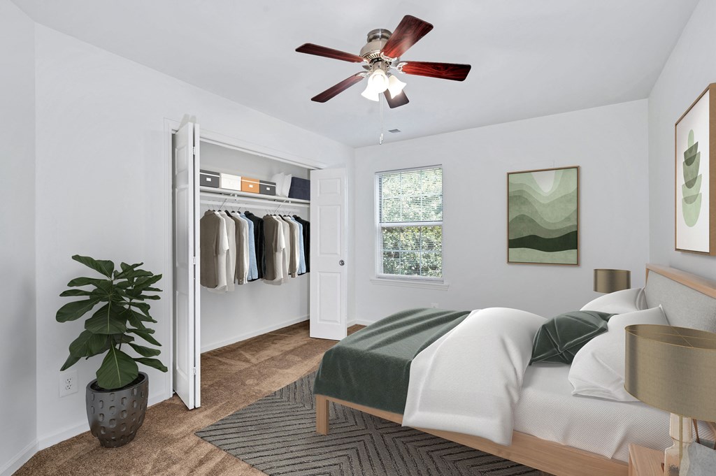 a bedroom with a bed and a ceiling fan