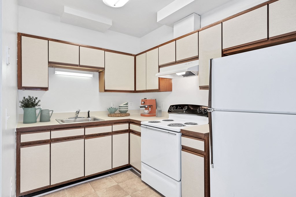 a kitchen with white appliances and wooden cabinets